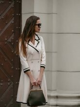 A lady wears a double breasted dress